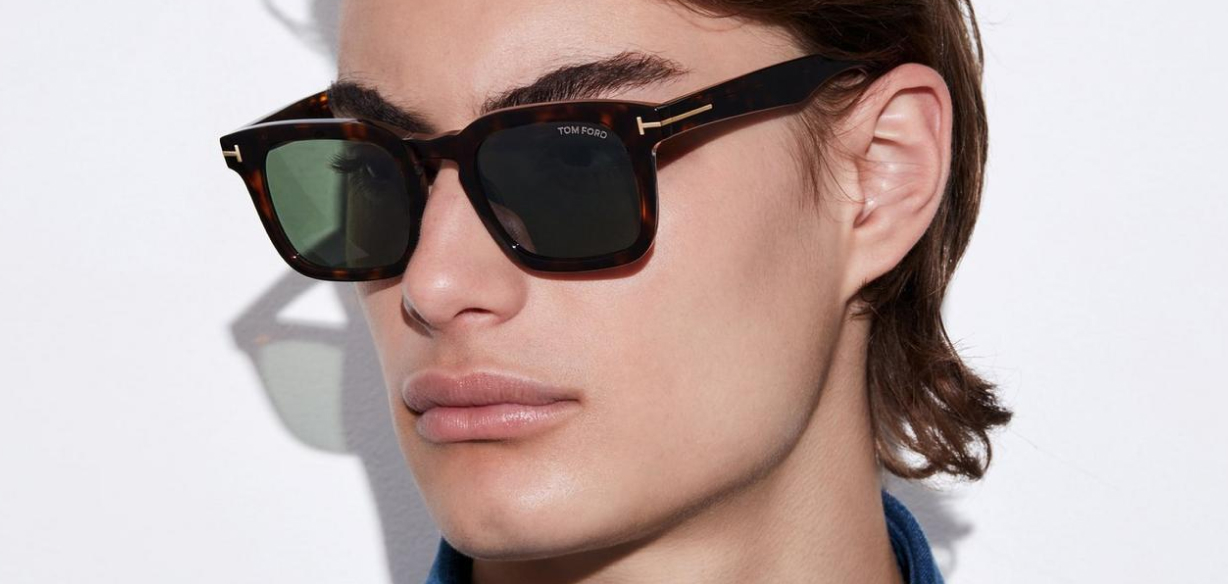 top brands of 2026 man wearing tom ford designer frame on blank background 